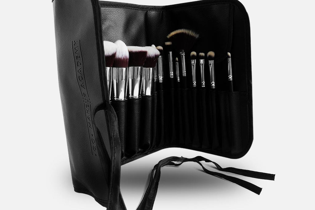 Set of makeup brushes in a black carrying case on a white background
