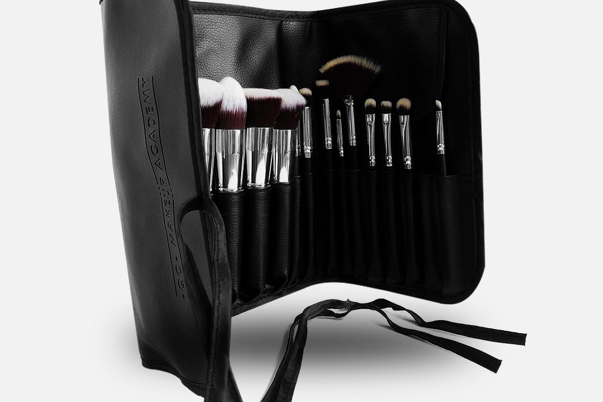 Set of makeup brushes in a black carrying case on a white background