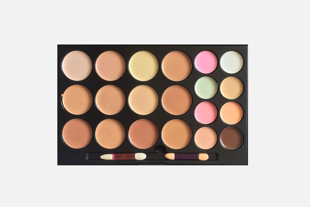 Makeup palette with various colors on a white background