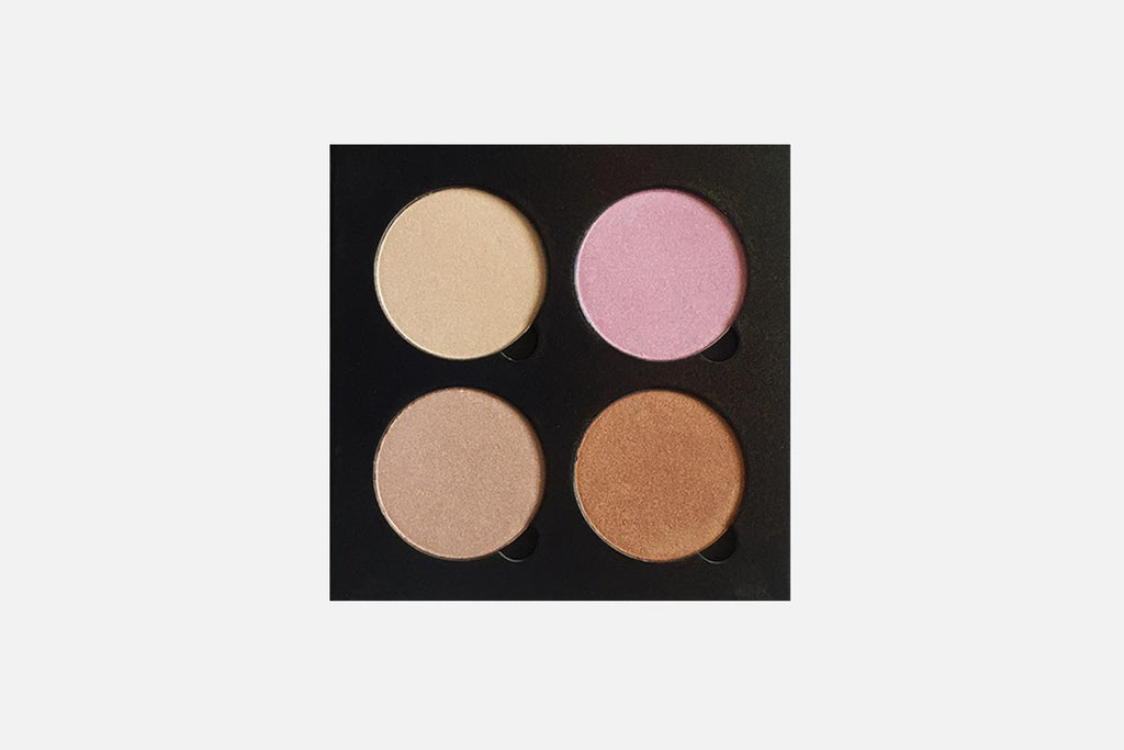 Makeup palette with four different shades on a light gray background