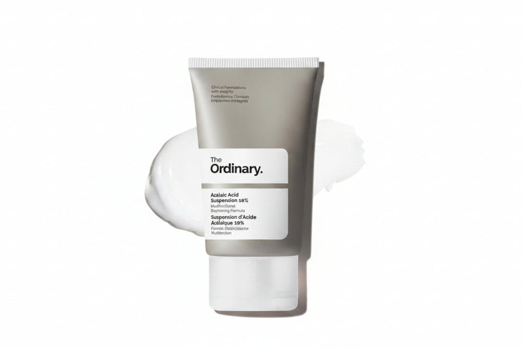 The Ordinary Acid-Acid Suspension 10% cleanser in a matte gray squeeze tube with a white label, shown against a white background with a white cream smear behind it.