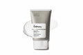 The Ordinary Acid-Acid Suspension 10% cleanser in a matte gray squeeze tube with a white label, shown against a white background with a white cream smear behind it.