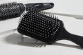 Black hairbrush with bristles on a white background