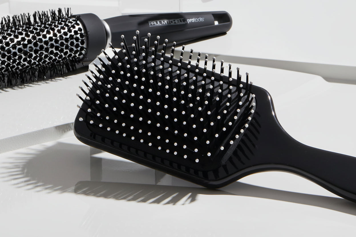 Black hairbrush with bristles on a white background