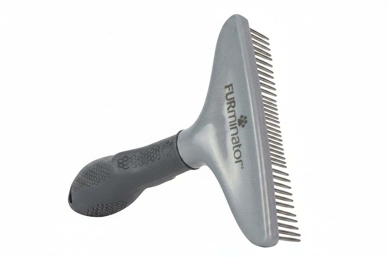 Gray grooming brush with comb attachment on a white background, featuring the FURMINATOR brand.