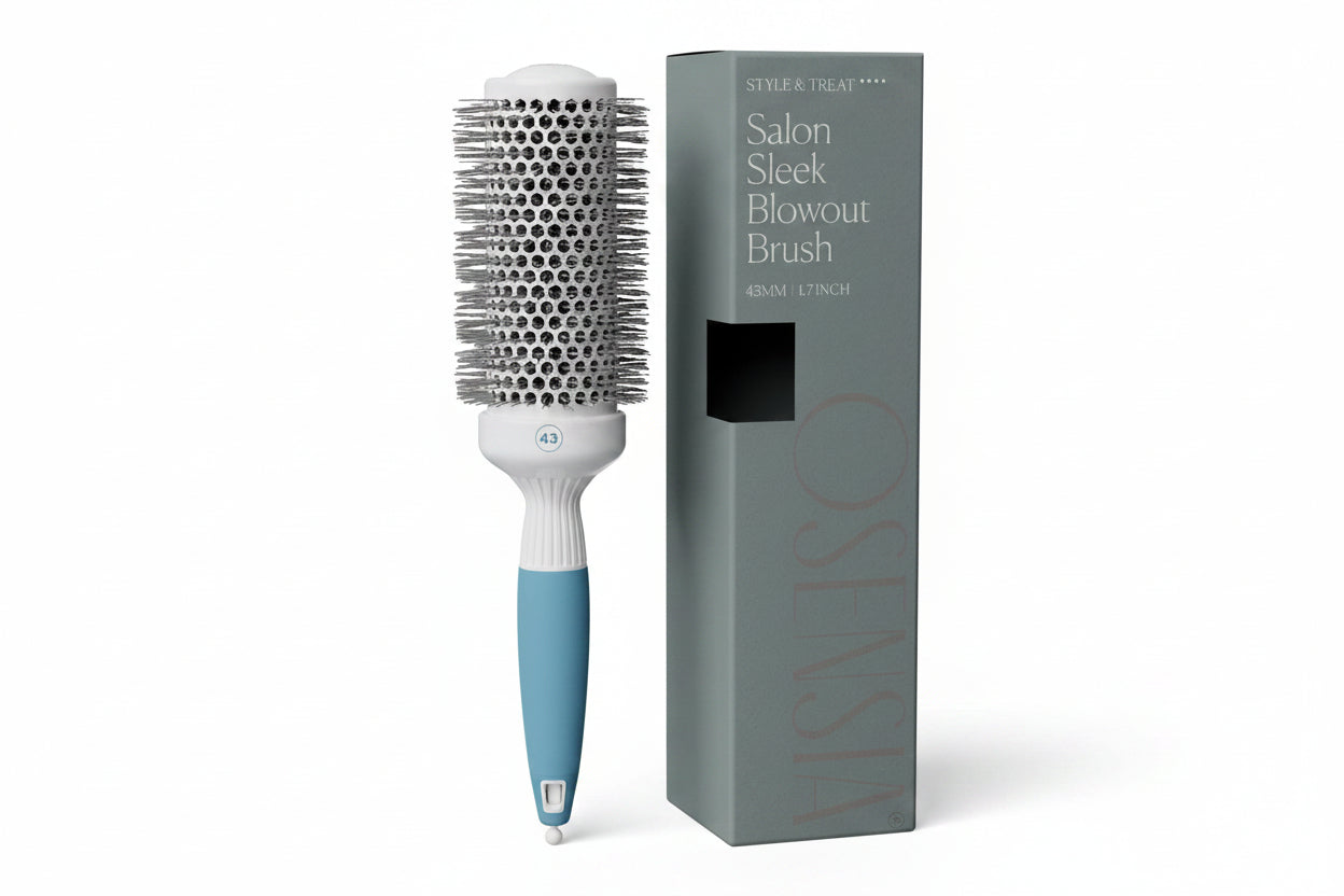 Hairbrush with blue handle and white bristle head next to its packaging on a white background