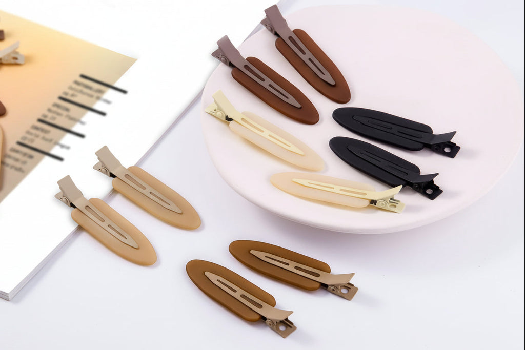 Set of no bend hair clips in various colors on a white surface.