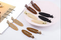 Set of no bend hair clips in various colors on a white surface.
