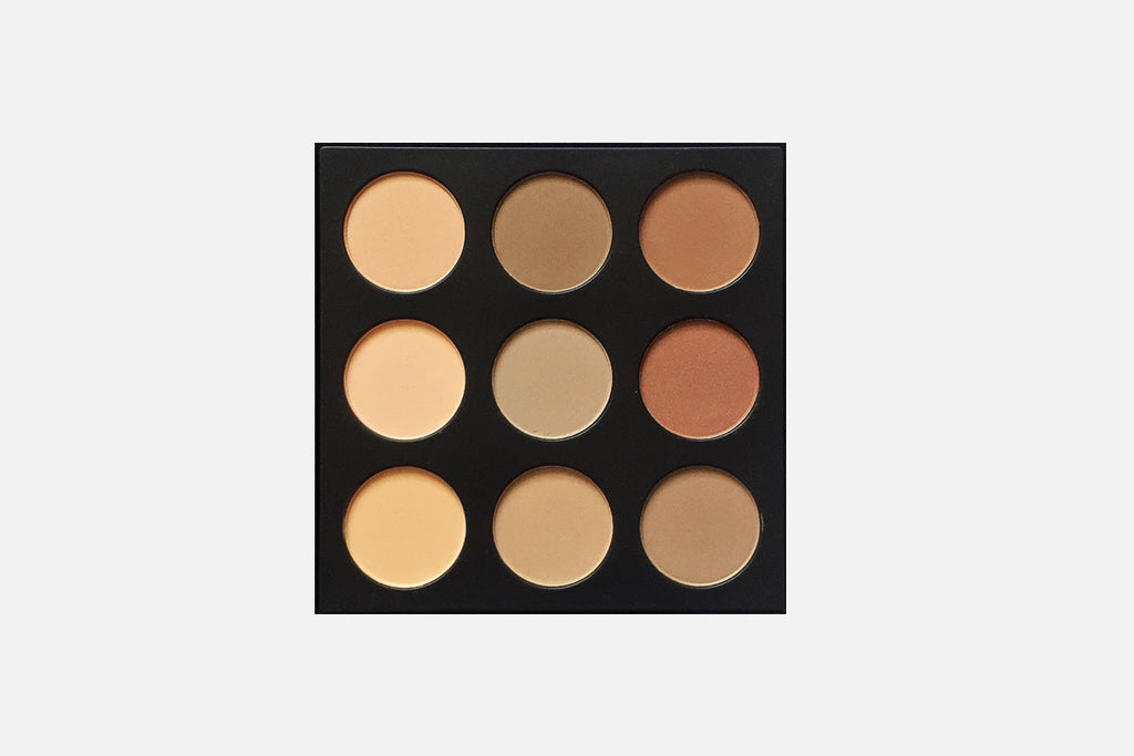 Makeup palette with nine circular compartments on a light gray background