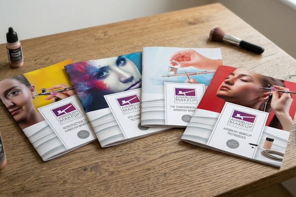 Makeup technique books and a brush on a wooden table