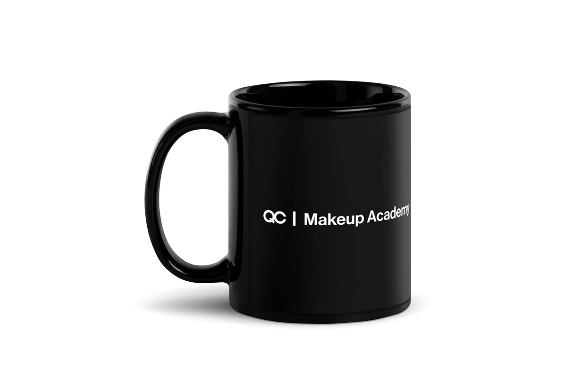Black mug that says "QC Makeup Academy" on white background.