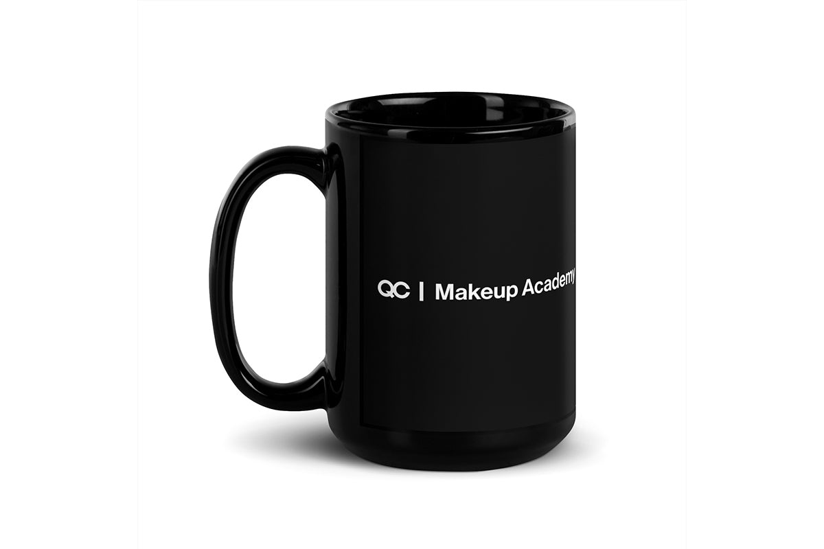 Black mug that says "QC Makeup Academy" on white background.