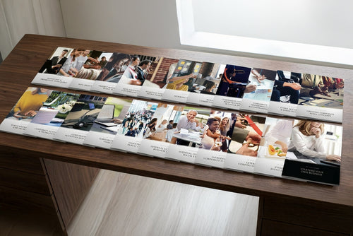 Long table with multiple educational booklets.