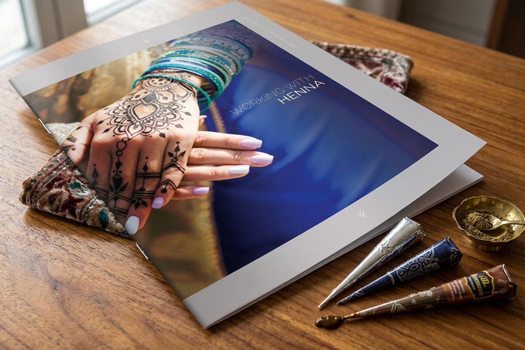 Makeup book on a wooden table with henna designs and tools