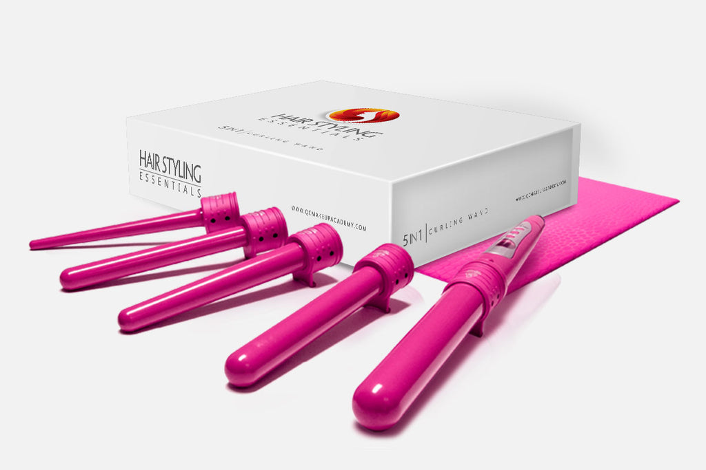 Set of pink hair curling irons with packaging on a white background