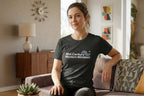 Woman wearing a 'Mid-Century Modern Mindset' t-shirt sitting on a couch in a living room.