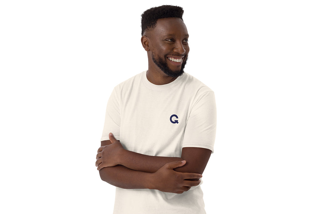 Man wearing a white t-shirt with a QC logo on a white background