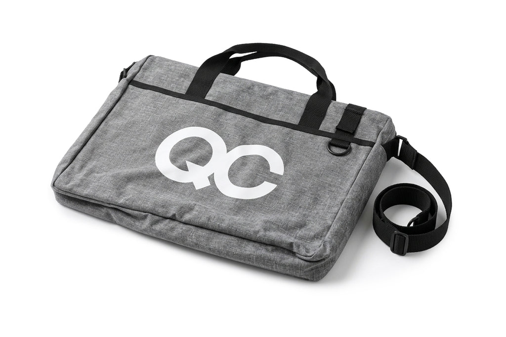Gray bag with 'QC' logo on a white background