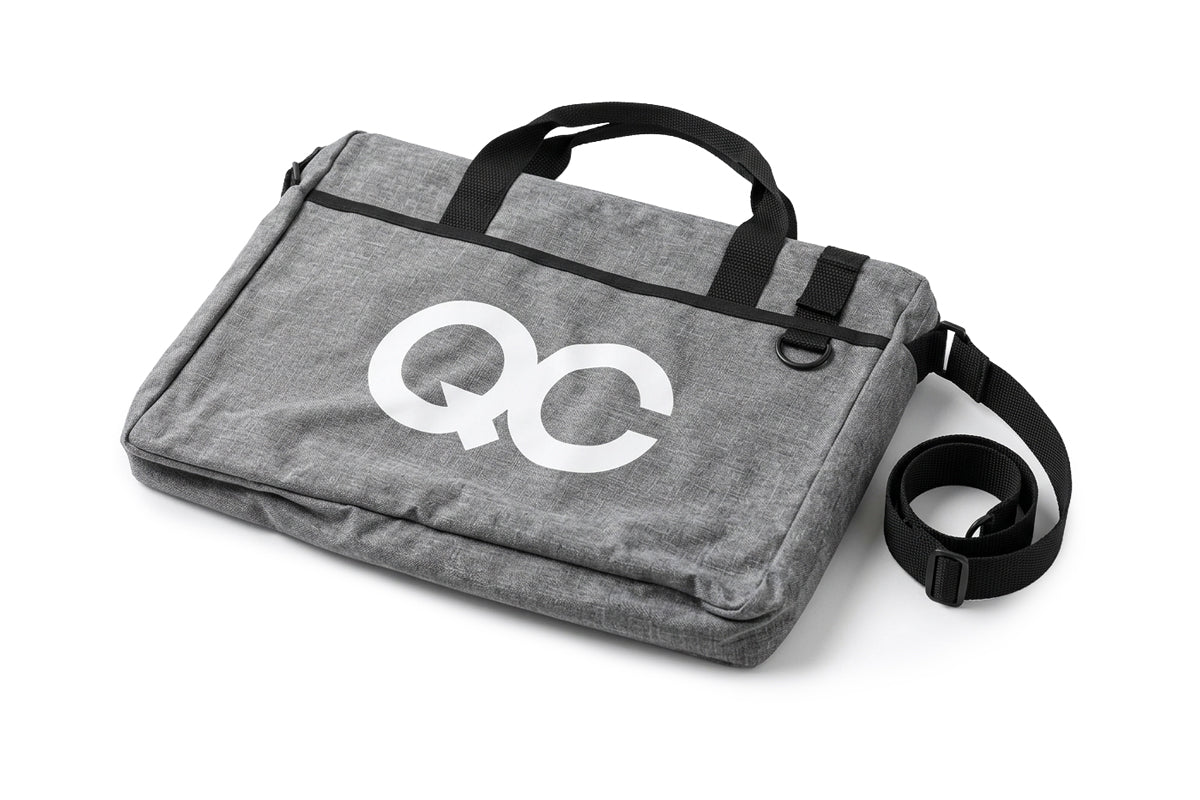 Gray bag with 'QC' logo on a white background
