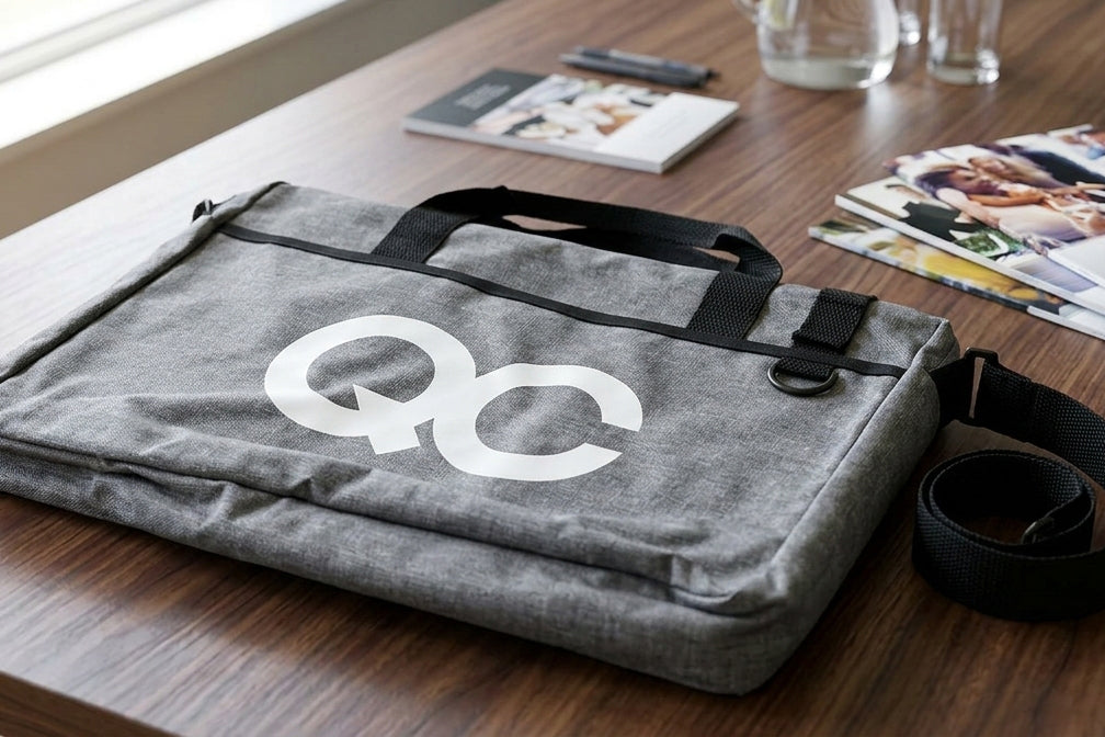 Gray bag with a logo on a wooden surface