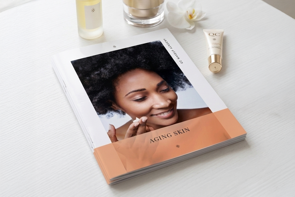 Book titled 'Aging Skin' with a woman's face on the cover, placed on a white surface with skincare products around.
