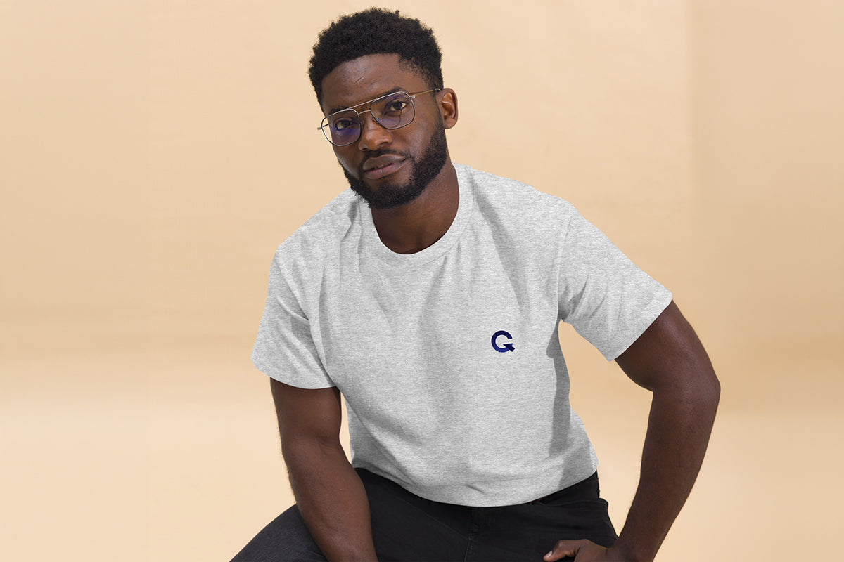 Man wearing a gray t-shirt with 'OC Design School' text on a beige background