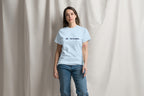 Person wearing a light blue t-shirt with QC Pet Studies logo on a plain background