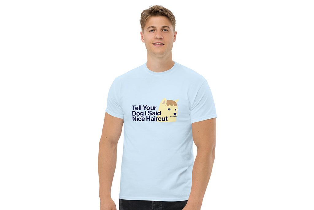 Person wearing a light blue t-shirt with a graphic and text on a white background