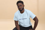 Man wearing a light blue t-shirt with 'OC Design School' text on a beige background