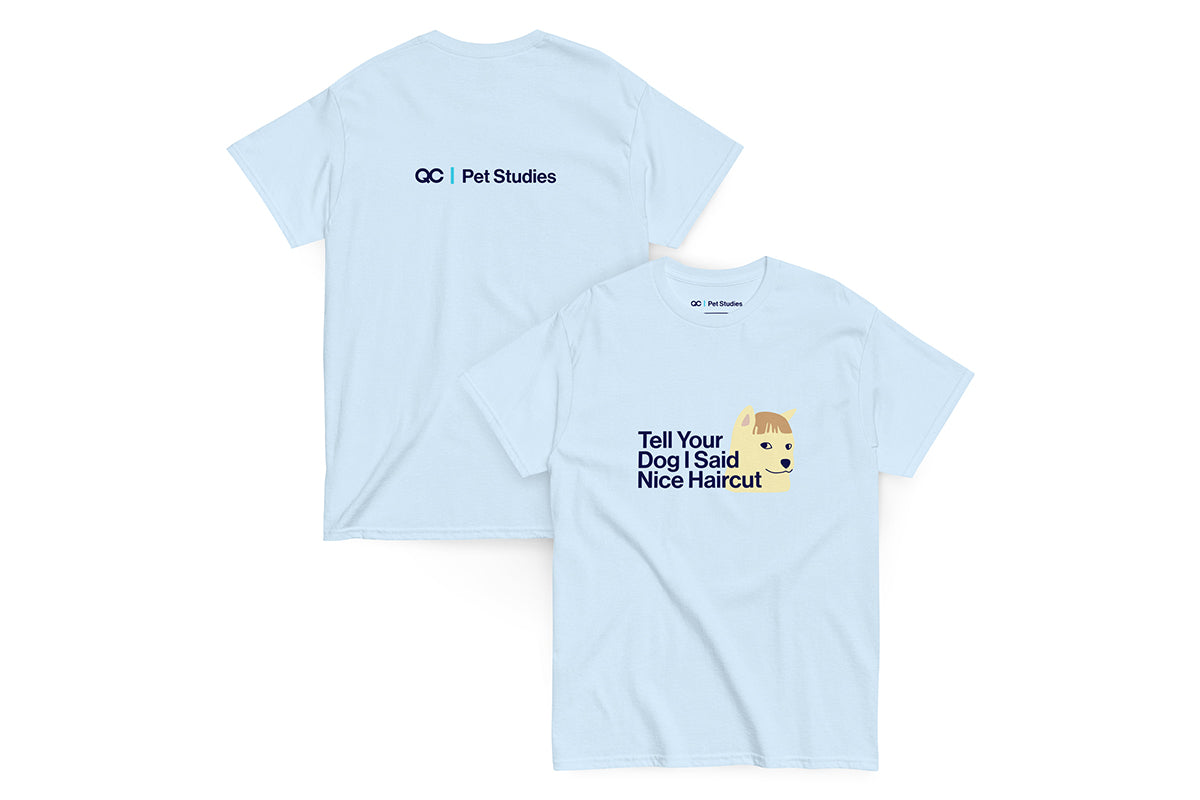 Front and back of blue t-shirt. Back reads "QC Pet Studies", front reads "Tell Your Dog I Said Nice Haircut"