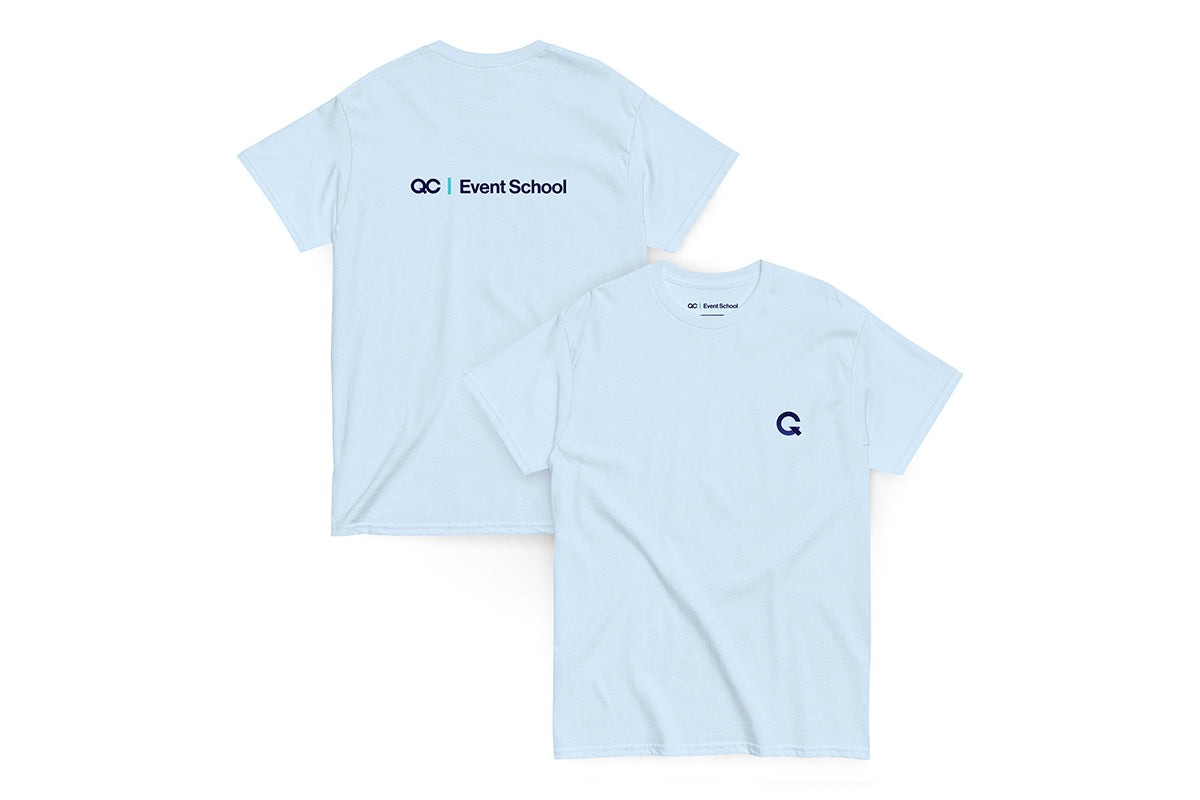 Back and front of a light blue t-shirt. Back reads "QC Event School" and front features Q logo.