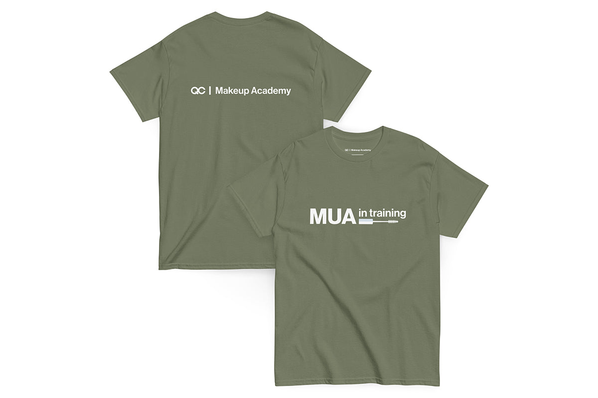 Green t-shirt with text 'MUA in Training' on a white background. Back of t-shirt reads "QC Makeup Academy".