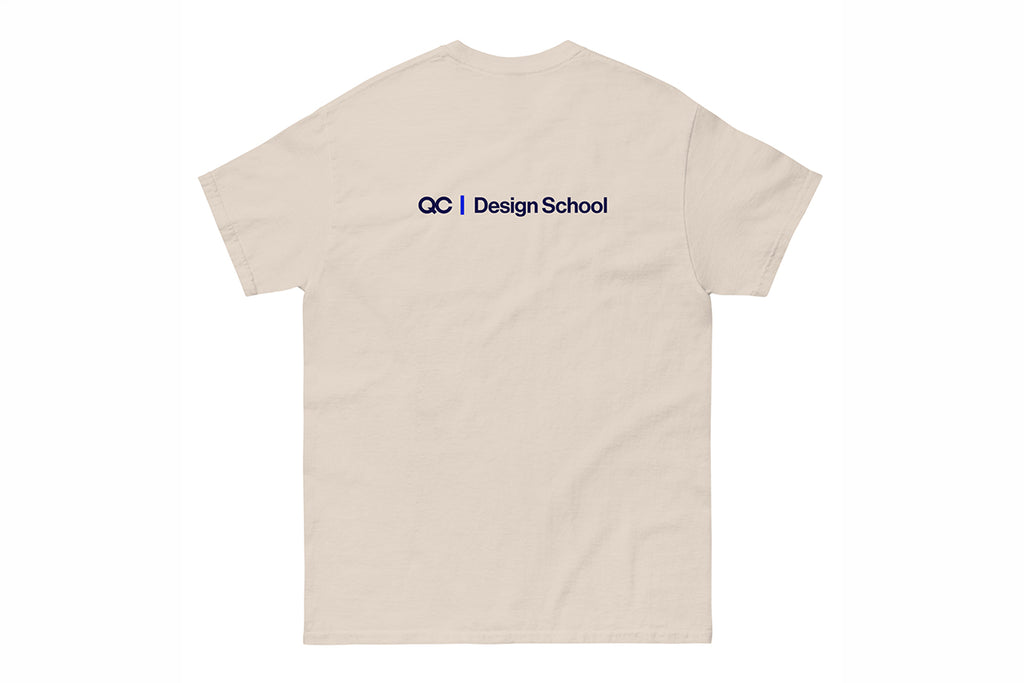 Beige t-shirt with a QC Design School logo on the back against a white background