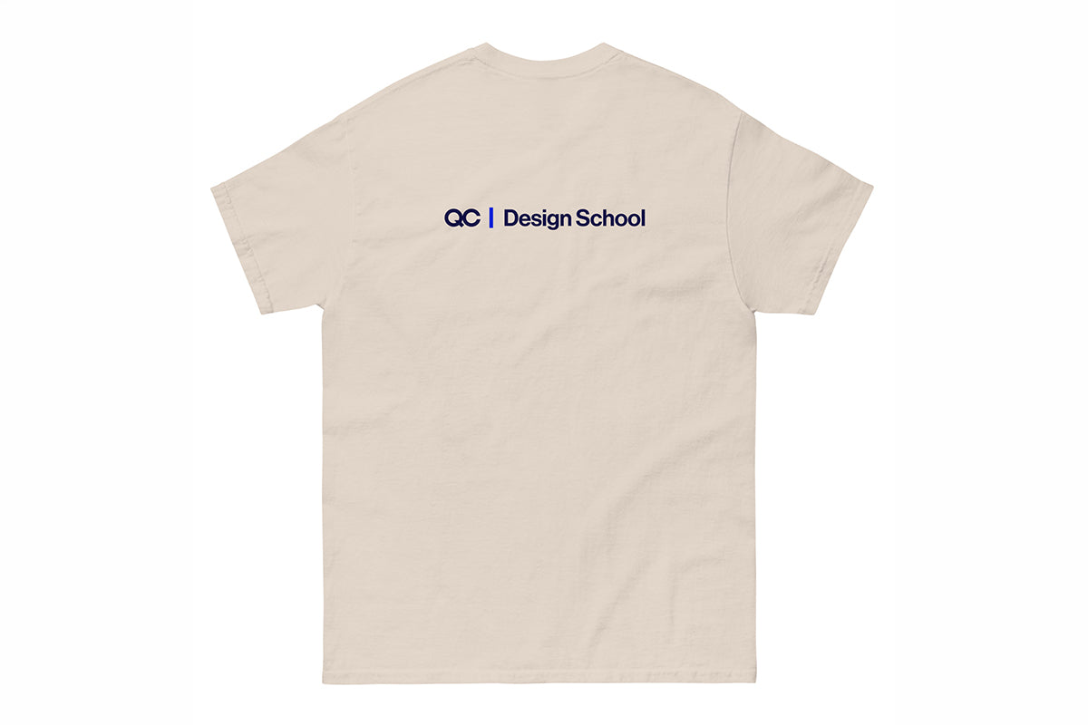 Beige t-shirt with a QC Design School logo on the back against a white background