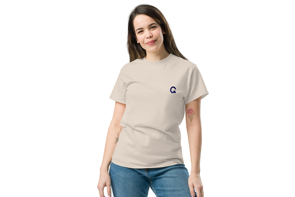 Woman wearing a beige t-shirt with a Q logo on a white background