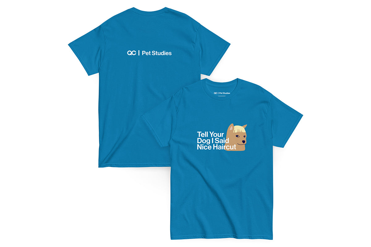 Blue t-shirt with text that reads "Tell Your Dog I Said Nice Haircut" and a dog graphic on a white background