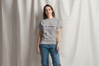 Person wearing a gray t-shirt with a QC Pet Studies logo against a plain background