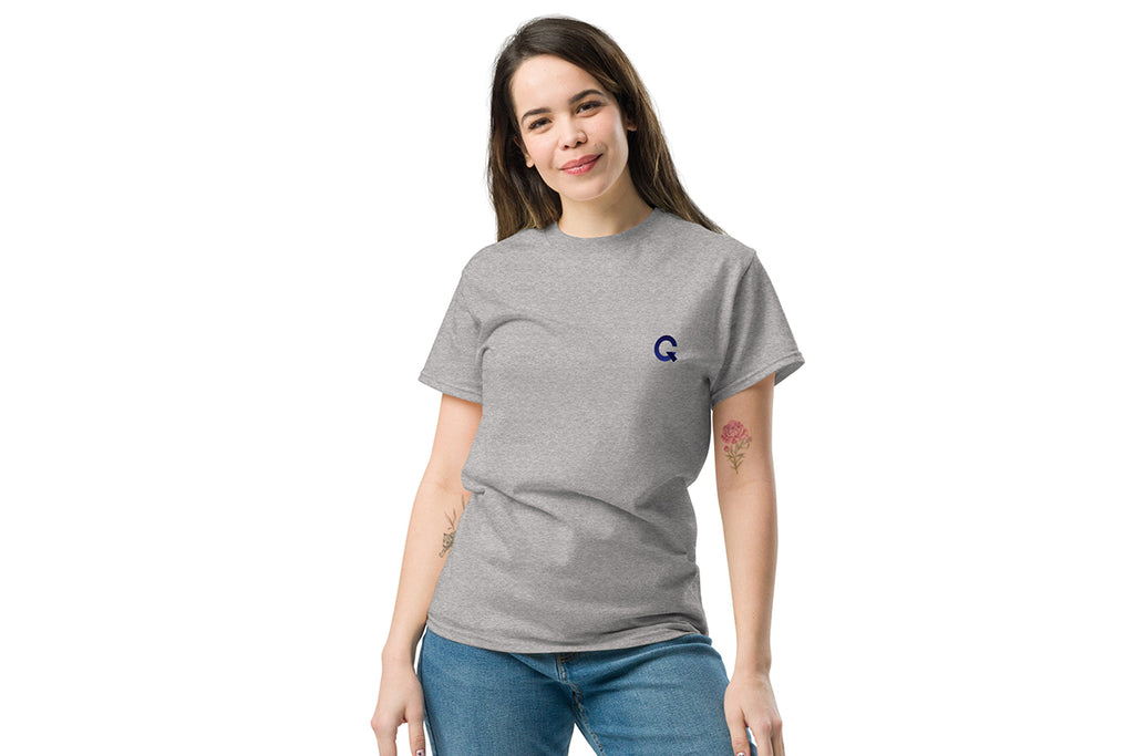 Woman wearing a gray t-shirt with a Q logo on a white background