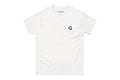 White t-shirt with a small Q logo on a white background