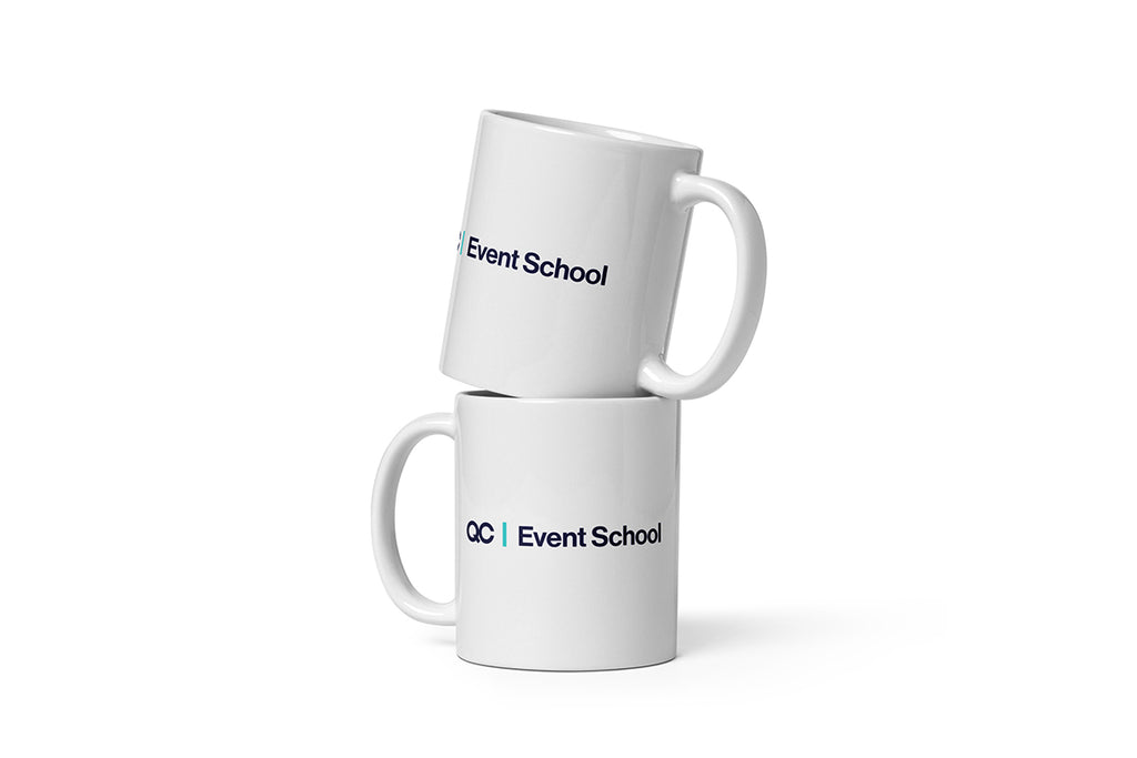 Two white mugs with 'QC Event School' text on a white background