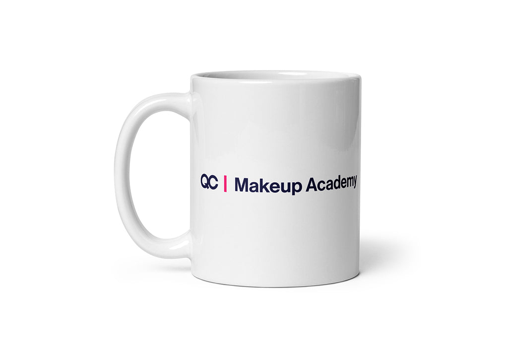 White mug with 'QC Makeup Academy' text on a white background