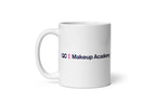 White mug with 'QC Makeup Academy' text on a white background