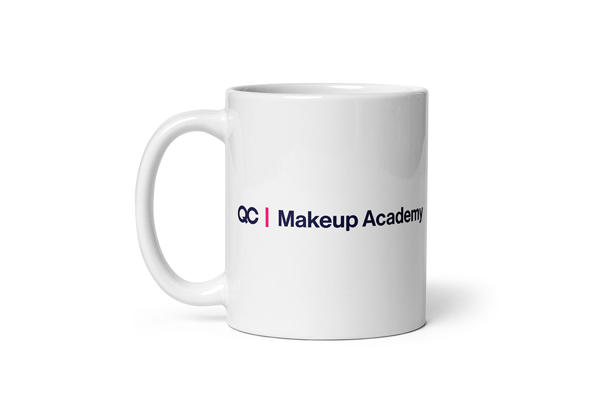 White mug with 'QC Makeup Academy' text on a white background