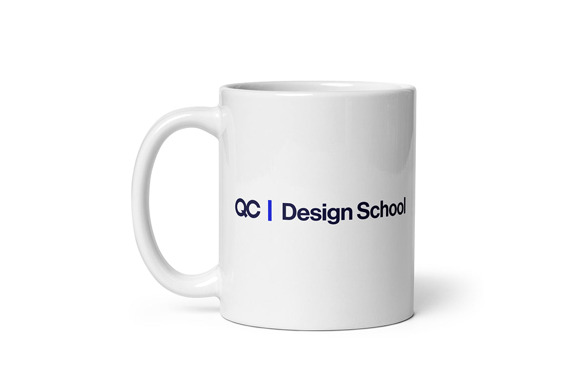 White mug with 'QC Design School' text on a white background