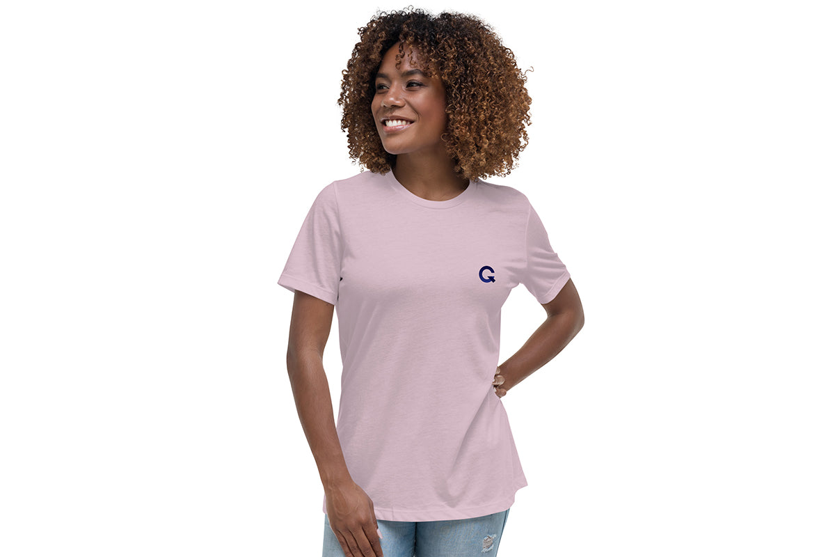 Woman wearing a light purple t-shirt with a Q logo on a white background