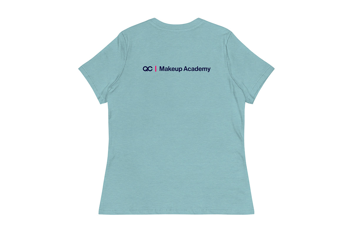 Back of light blue t-shirt with 'QC Makeup Academy' text on the back against a white background