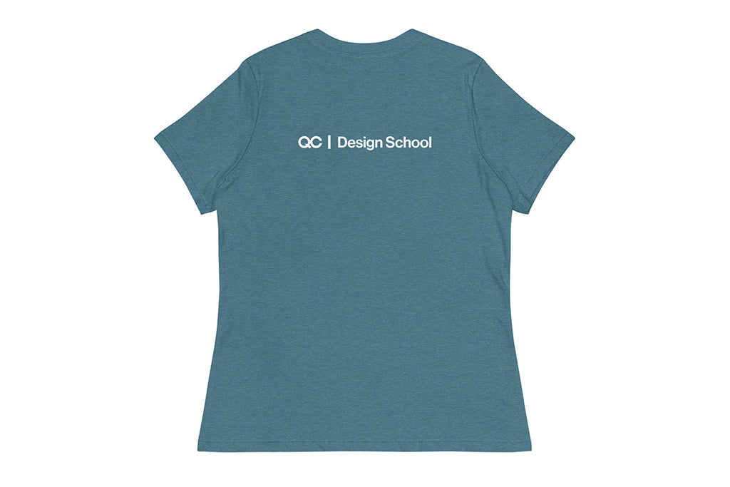 Blue t-shirt with 'QC Design School' text on the back against a white background