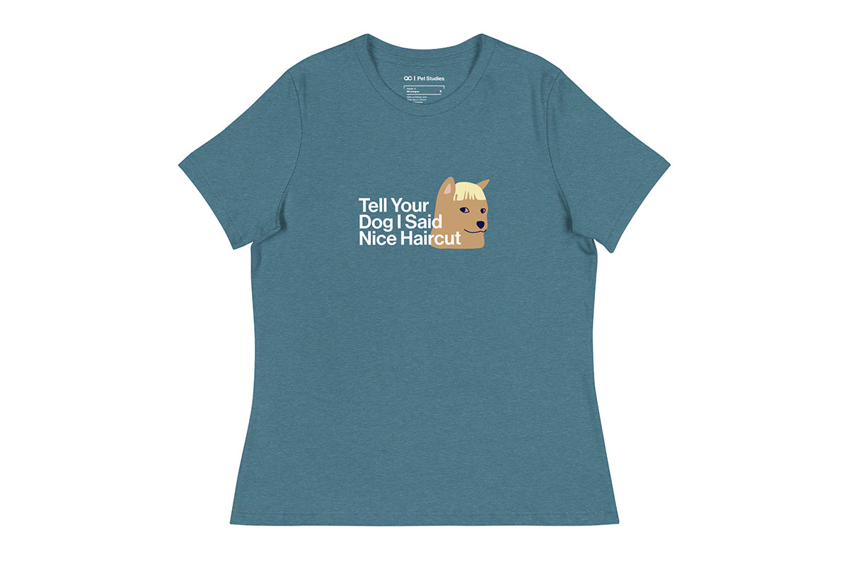 Blue t-shirt with a graphic of a dog and text that reads "Tell Your Dog I Said Nice Haircut" on a white background