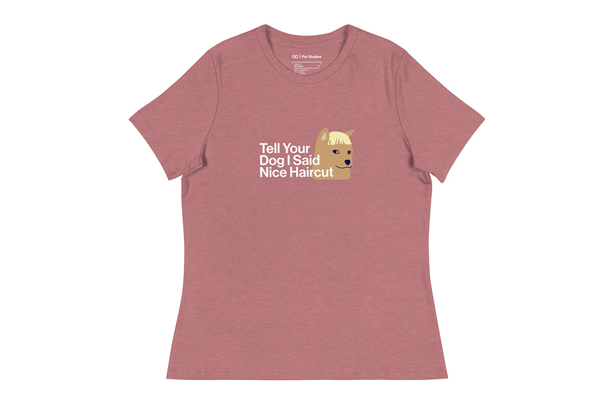 Pink t-shirt with a graphic of a dog and text that reads "Tell Your Dog I Said Nice Haircut" on a white background