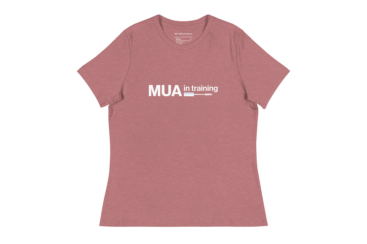 Pink t-shirt with 'MUA in training' text on a white background
